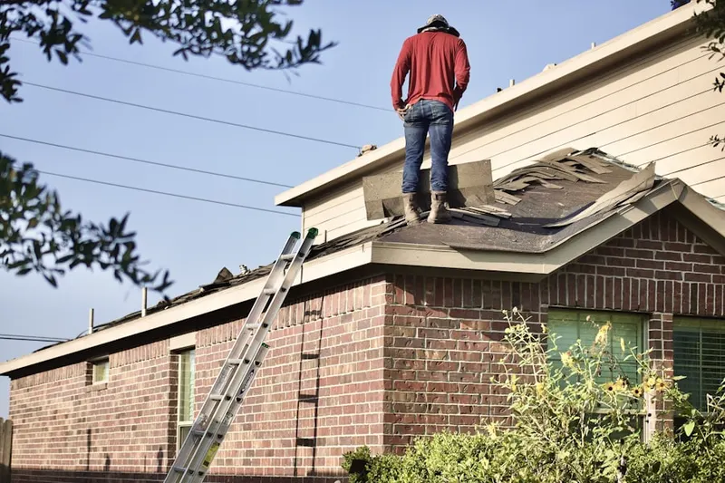 Professional roofer working on a residential roof in International Falls